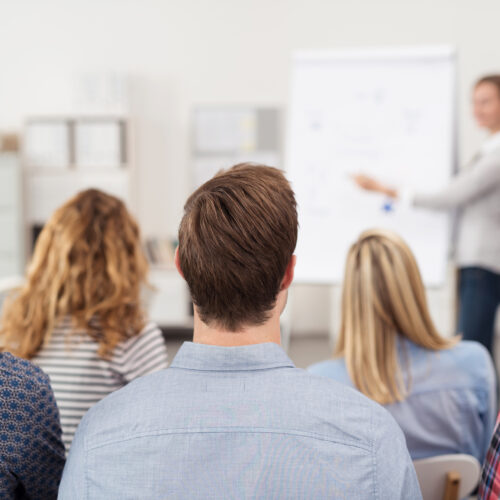 a group of younger office workers going through a training session